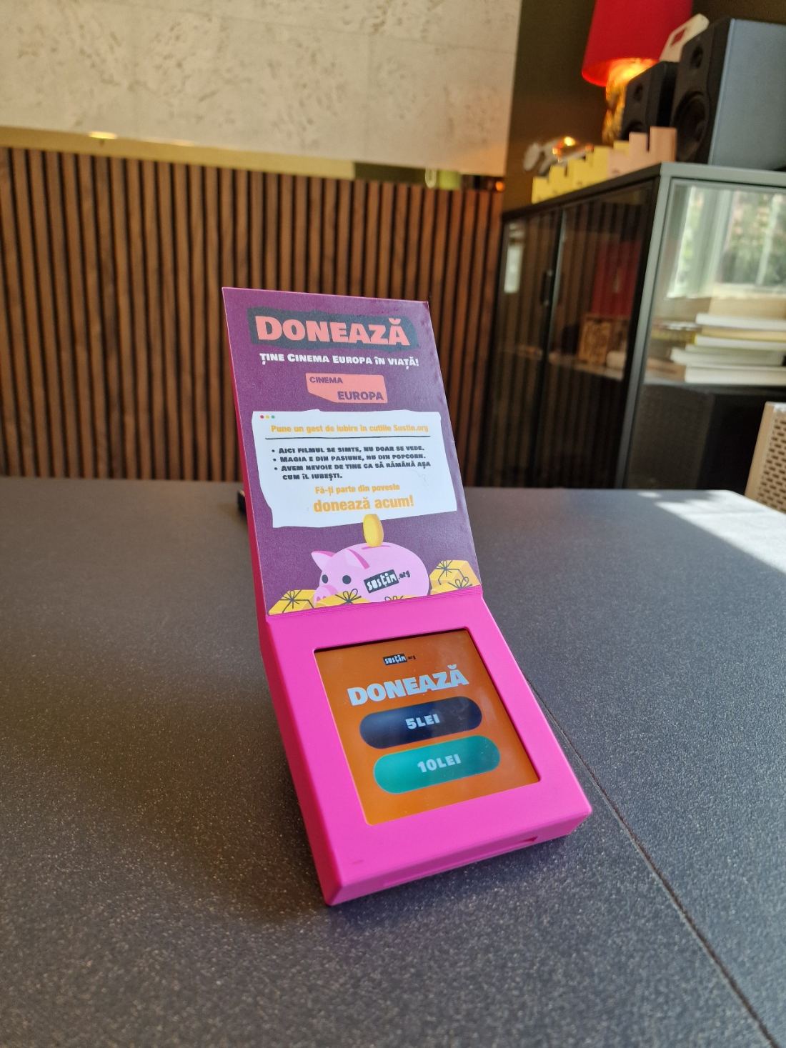 A pink Susțin box, with a Cinema Europa message and a donation screen