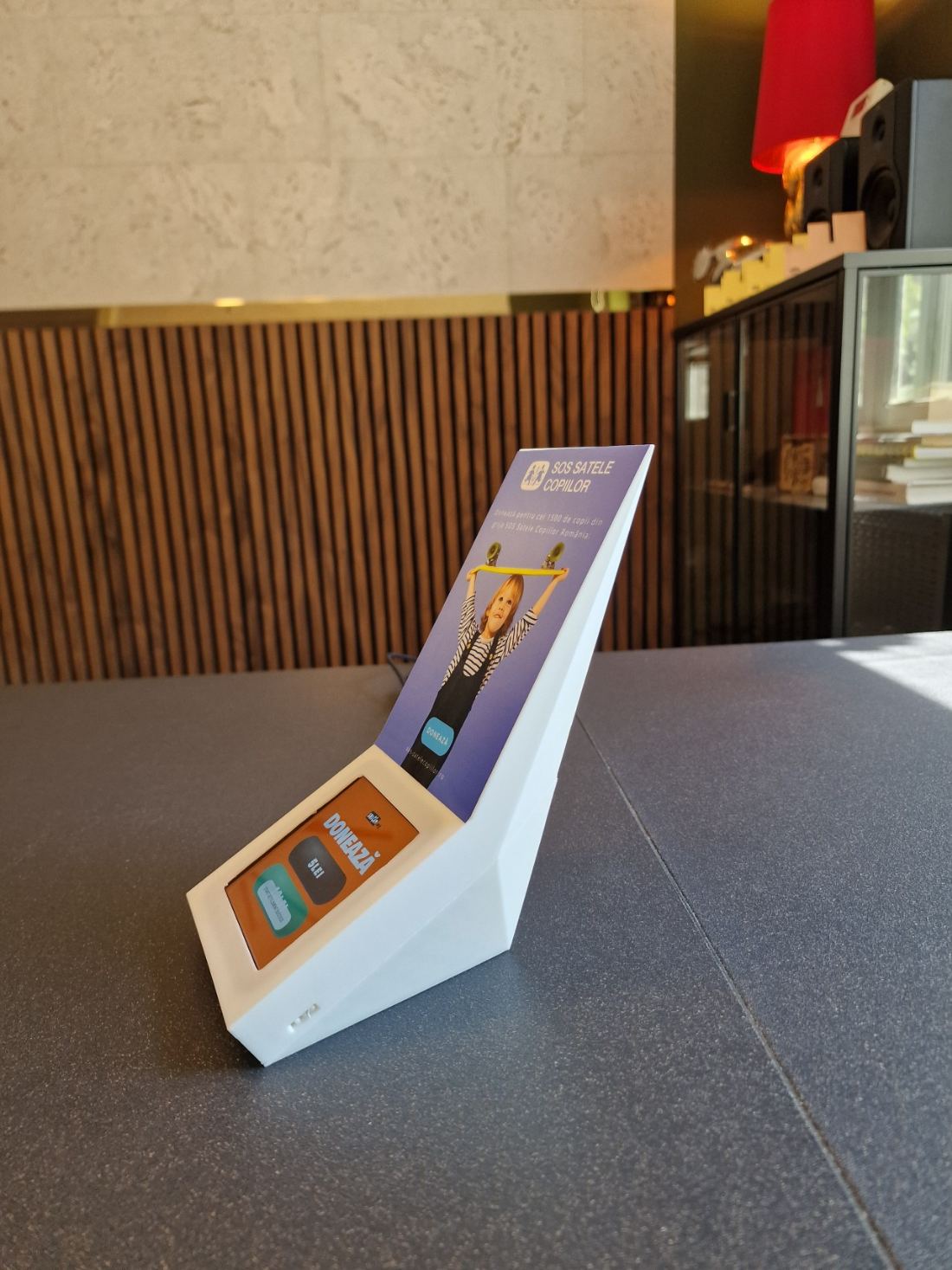 A white box seen from the side, with its angled base and vertical panel