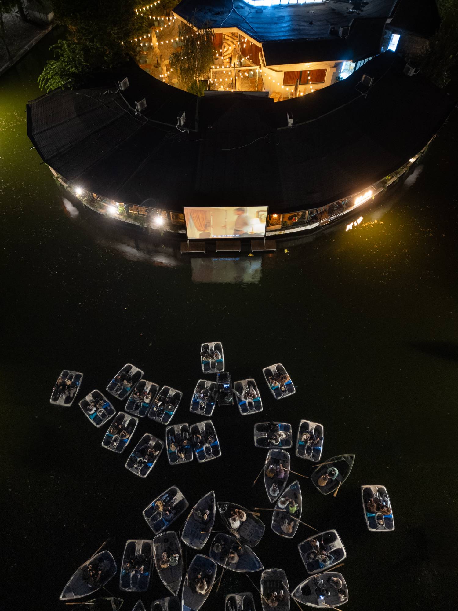 An aerial view of the boats in front of the screen.
