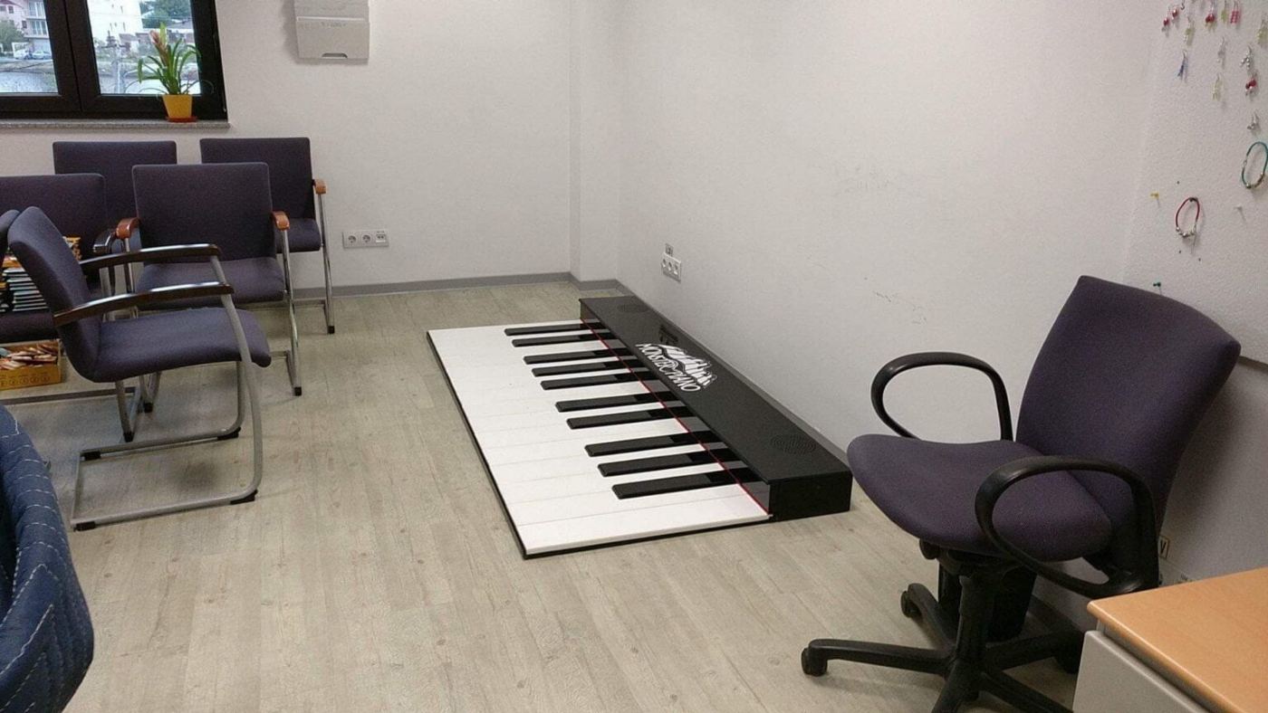 The piano’s large keys laid out on the floor of the room